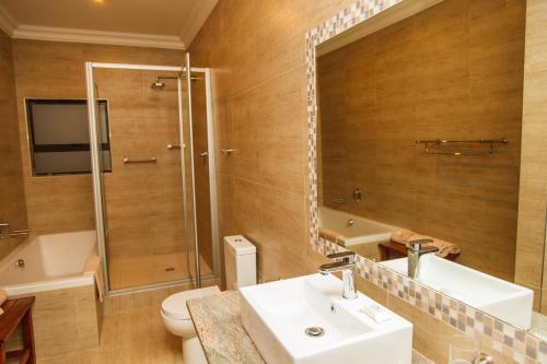 a bathroom with a sink and a shower and a toilet at Blyde Canyon, A Forever Resort in Matibidi