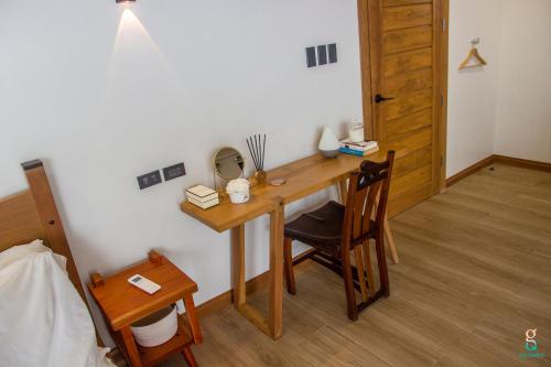 a wooden desk in a room with a chair at GQ Sands in Tangalan