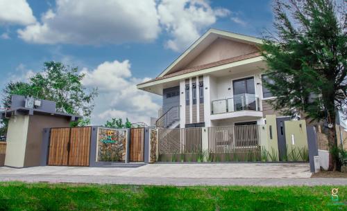 a house with a gate and a fence at GQ Sands in Tangalan