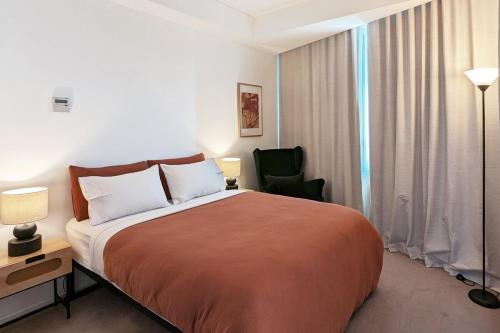 a hotel room with a large bed and a chair at Free Parking 2 Bedroom at Haymarket Chinatown Near Light Rail in Sydney