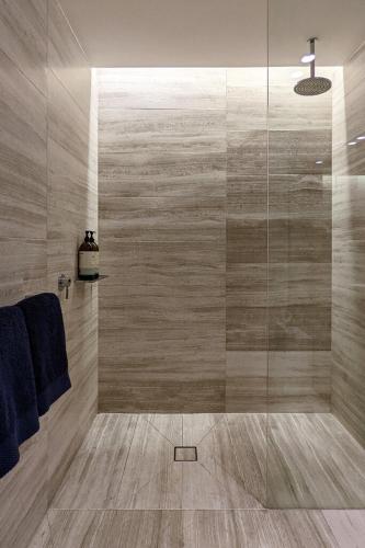 a bathroom with a shower with a glass door at Free Parking 2 Bedroom at Haymarket Chinatown Near Light Rail in Sydney