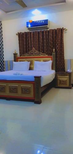 a bedroom with two beds with white pillows at Glorious Guest House & Hotel in Multan