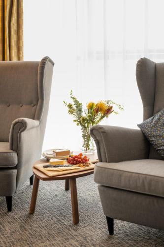 a living room with two chairs and a coffee table at Ozone Hotel Kangaroo Island in Kingscote