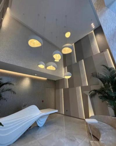 a room with a bed and lights on the ceiling at Harmony Espectacular departamento de lujo con áreas sociales in Quito