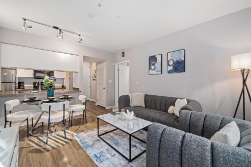 a living room with a couch and a table at Location Walk to the beach Chic Condo! in Los Angeles