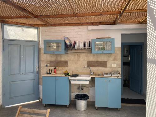 a kitchen with a sink and a blue door at Mariz unique studio in Cairo