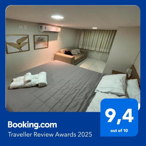 a hotel room with a bed with a towel on it at Tambaú Israel Flat 421 - cobertura com piscina beira mar in João Pessoa