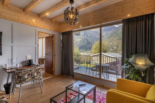 a living room with a view of a mountain at Echor Himalayan Heights Luxe Manali in Manāli