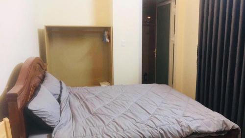 a bedroom with a bed and a door to a closet at Mây Villa in Da Lat