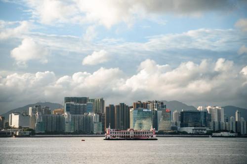 a boat in the water in front of a city at ibis Hong Kong North Point in Hong Kong