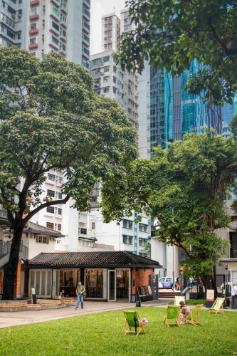 a group of people sitting in chairs in a park at ibis Hong Kong North Point in Hong Kong