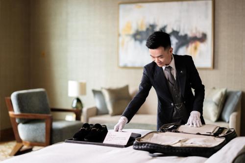 a man in a suit standing over a table at The St. Regis Istanbul in Istanbul