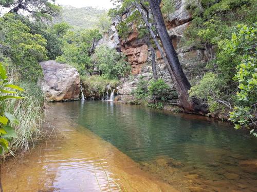 a river in a canyon with a waterfall at Blyde Canyon, A Forever Resort in Matibidi