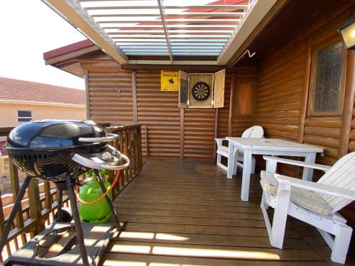 a grill on the deck of a cabin at Shore Enuff - Ocean and Garden View in Jeffreys Bay