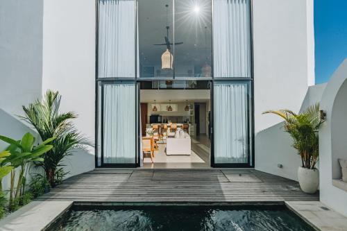 a house with a pool in the middle of a house at 2BR Ricefield View Villa in Munggu Easy Beach Access in Munggu