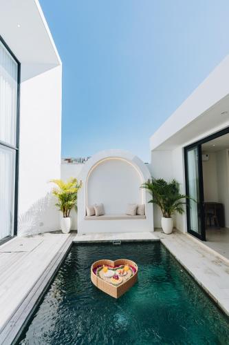 a swimming pool in a house with a bed in the background at 2BR Ricefield View Villa in Munggu Easy Beach Access in Munggu
