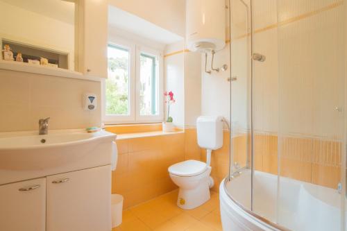 La salle de bains est pourvue de toilettes, d'une douche et d'un lavabo. dans l'établissement Hostel Marinero, à Hvar