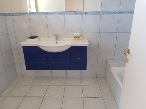 a white bathroom with a sink and a tub at Marlborough Suite in an 6-bedroom luxury villa in Blenheim