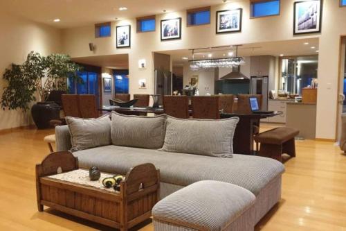 a living room with a couch and a dining room at Chagall Suite in an 6-bedroom luxury villa in Blenheim