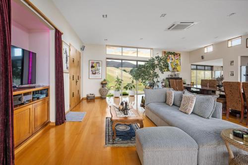 a living room with a couch and a table at Chagall Suite in an 6-bedroom luxury villa in Blenheim
