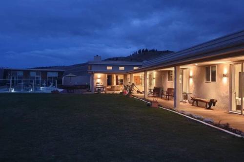 a house with a large yard in front of it at Cloudy Bay Suite in an 6-bedroom luxury villa in Blenheim