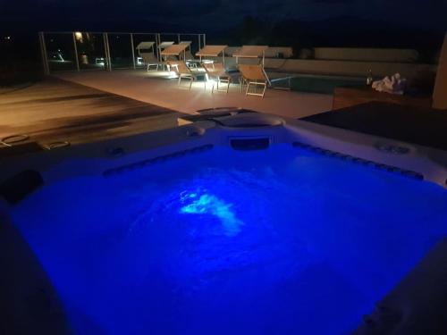 a swimming pool with blue lights in a room at Cloudy Bay Suite in an 6-bedroom luxury villa in Blenheim