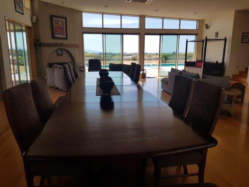 a large dining room with a table and chairs at Cloudy Bay Suite in an 6-bedroom luxury villa in Blenheim