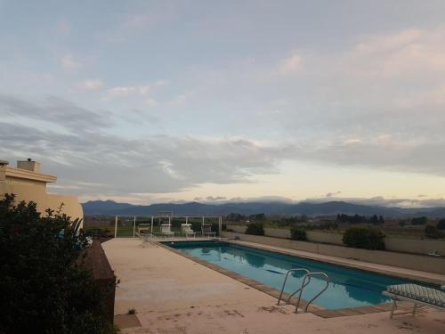 a swimming pool on top of a building with mountains in the background at Cloudy Bay Suite in an 6-bedroom luxury villa in Blenheim