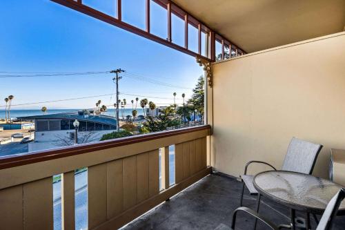 a balcony with a table and chairs and a view of the ocean at Howard Johnson by Wyndham Santa Cruz in Santa Cruz
