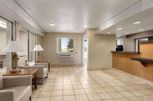 a living room with a couch and a table at Super 8 by Wyndham Joliet I-55 N/Chicago in Joliet