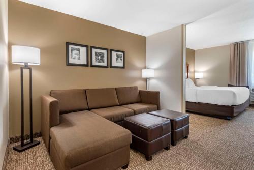 a hotel room with a couch and a bed at Comfort Inn in Crawfordsville