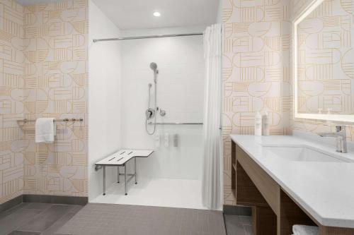 a bathroom with a shower and a sink at Home2 Suites By Hilton Eureka in Eureka