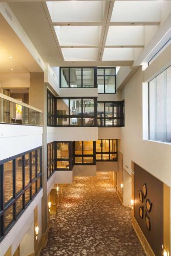 an empty hallway in a building with windows at Hilton Orange County/Costa Mesa in Costa Mesa