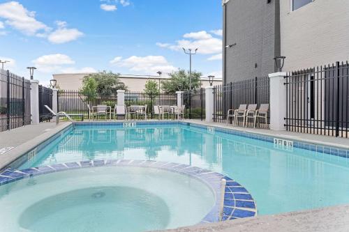 a large swimming pool in front of a building at Hawthorn Extended Stay by Wyndham Port Arthur in Port Arthur