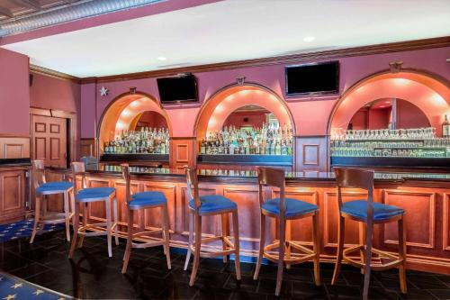 a bar in a restaurant with blue stools at Wyndham Gettysburg Hotel & Conference Center in Gettysburg