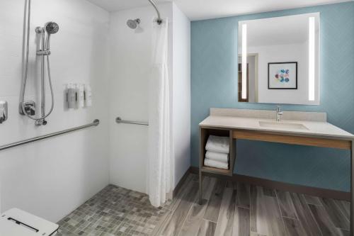 a bathroom with a sink and a shower at Hilton Garden Inn Rockaway in Rockaway