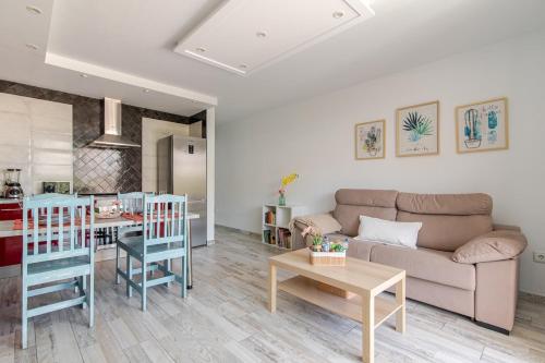a living room with a couch and a table at Refreshing Oasis in El Médano