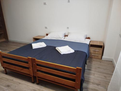 a bedroom with a bed with two towels on it at Апарт-готель Олімпік in Lviv