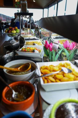 a buffet with many different dishes of food on a table at Sheki Palace Hotel in Sheki