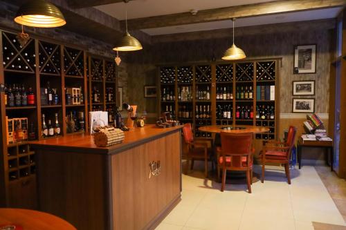 a bar in a wine cellar with a table and chairs at Sheki Palace Hotel in Sheki