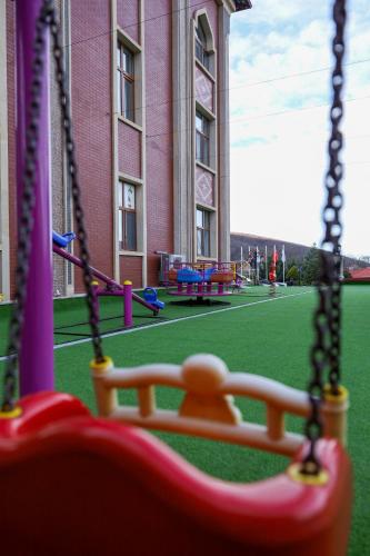 an empty playground in a building with a swing at Sheki Palace Hotel in Sheki