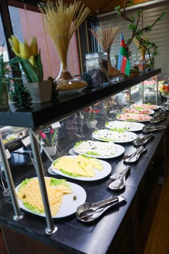 a buffet line of plates of food on a table at Sheki Palace Hotel in Sheki