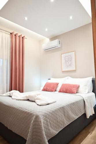 a bedroom with a large bed with red pillows at Dido's house in Volos