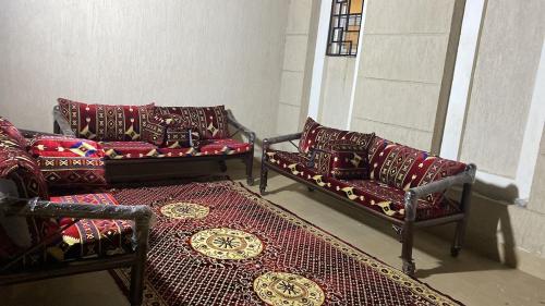 a living room with two couches and a rug at ڤيلا المرجان للعائلة Murjan Family Villa in Yanbu