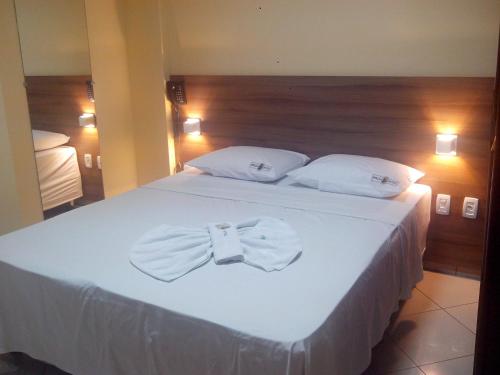 Ένα ή περισσότερα κρεβάτια σε δωμάτιο στο Estação Hotel