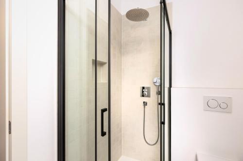 a shower with a glass door in a bathroom at Milnamour, Whole House by the Sea with Parking in Hvar