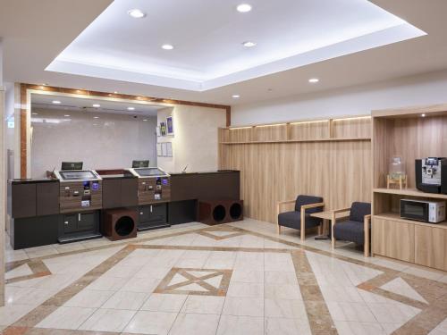an office with desks and chairs in a room at Hotel Villa Fontaine Tokyo-Jimbocho in Tokyo