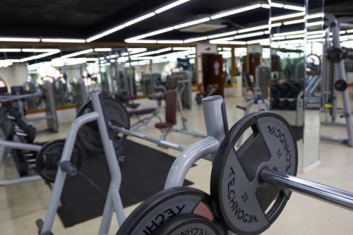 a gym with rows of dumbbells at Sheki Palace Hotel in Sheki