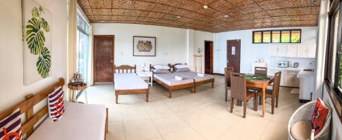 a living room with a couch and a table at Wuthering Heights Bed & Breakfast by the Sea in Dumaguete