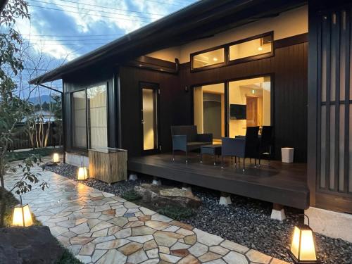 a home with a patio with a table and chairs at 箱根リゾート yamaki in Hakone